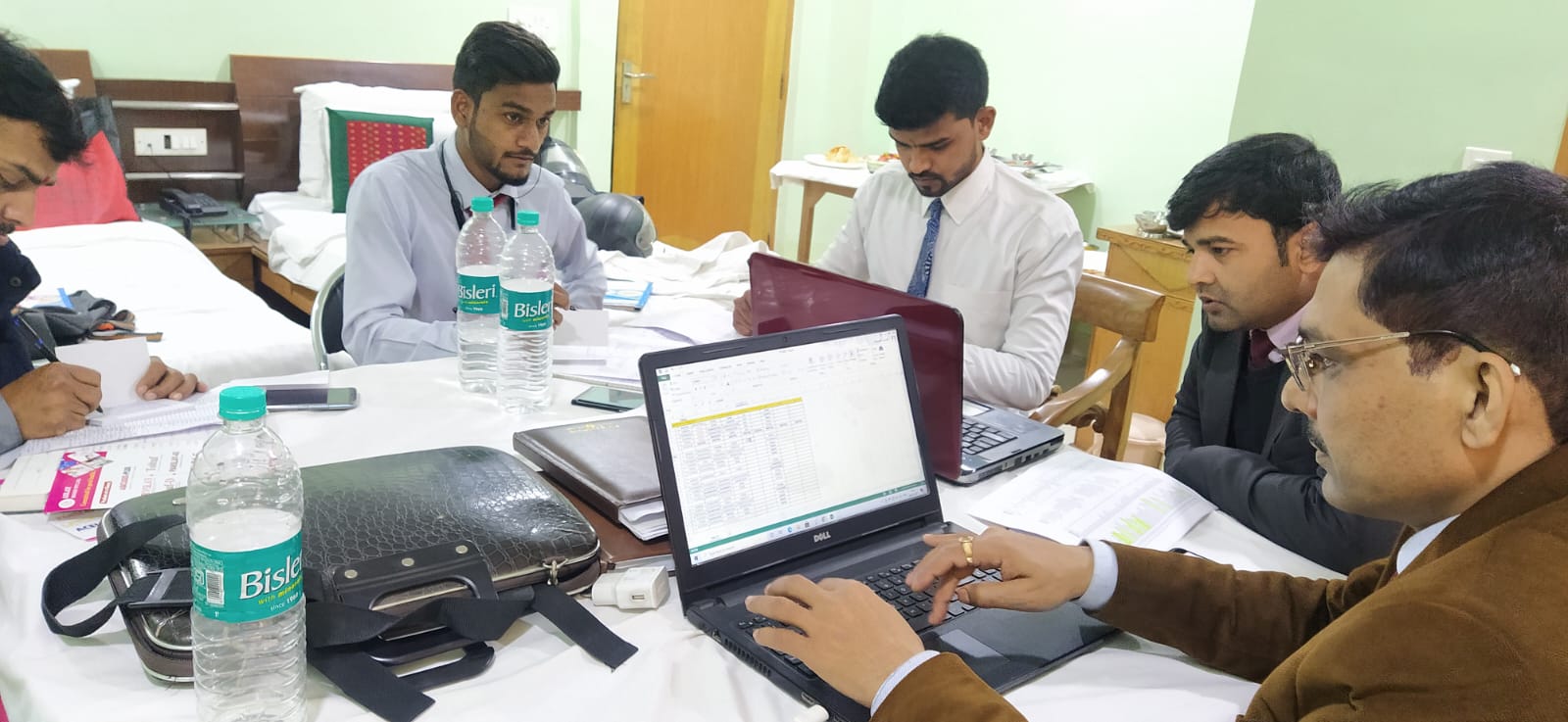 Aslay Biogen managers reviewing sales data during a team working session